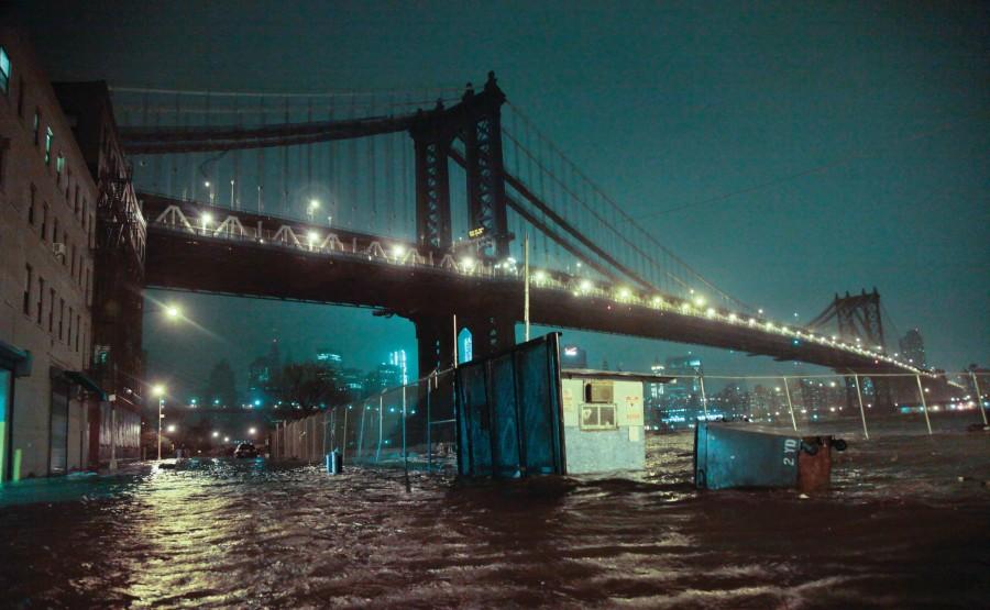 Streets are flooded under the Manhattan Bridge in the Dumbo section of Brooklyn, N.Y., Monday, Oct. 29, 2012. Sandy continued on its path Monday, as the storm forced the shutdown of mass transit, schools and financial markets, sending coastal residents fleeing, and threatening a dangerous mix of high winds and soaking rain. (Photo by Bebeto Matthews/ Associated Press)