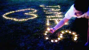 Candles are lighted on the town common during a vigil for James Foley in his hometown of Rochester, N.H., Saturday, Aug. 23, 2014. Foley, a freelance journalist, was killed earlier in the week by Islamic State militants. He was abducted in November 2012 while covering fighting in Syria. Photo by Jim Cole / Associated Press.