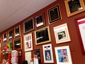 An entire wall covered in plaques, old newspaper articles and awards welcomes patrons to Simma's.