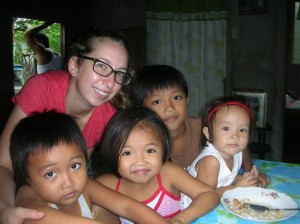 Marquette graduate Colleen Ross poses with children at Casa Bayanihan, Philippines, during her study abroad trip to the area. Photo courtesy of the Office of International Education. Photo courtesy of the Office of International Education.