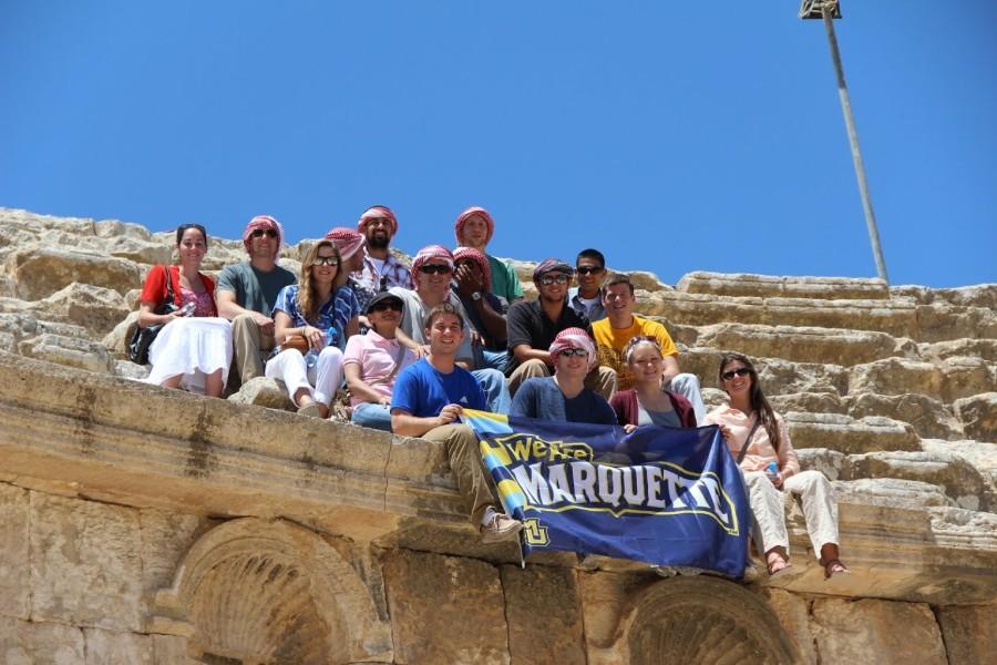 Students pose with a Marquette banner while studying in Jordan. Photo courtesy of the Office of International Education.