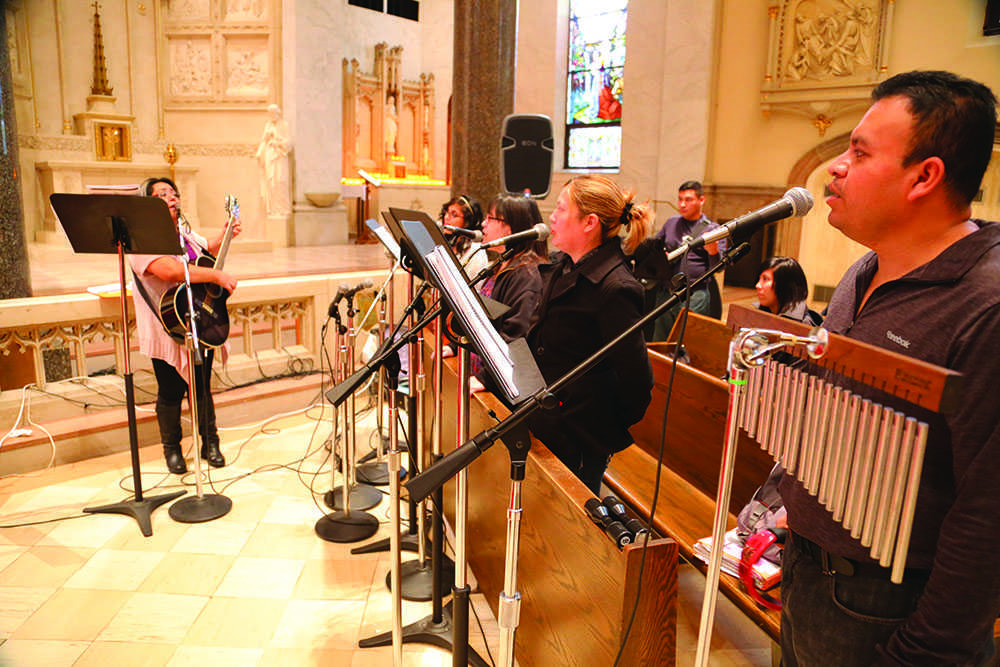 Musicians at Gesu Parish sing in Spanish during a mass in November, the third mass offered in the language by the parish. Photo by Yue Yin / yue.yin@marquette.edu