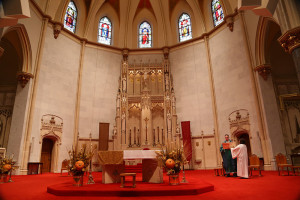 The Rev. Matthew Walsh, associate pastor at Gesu Parish, leads the church during a prayer at an all-Spanish mass in November.