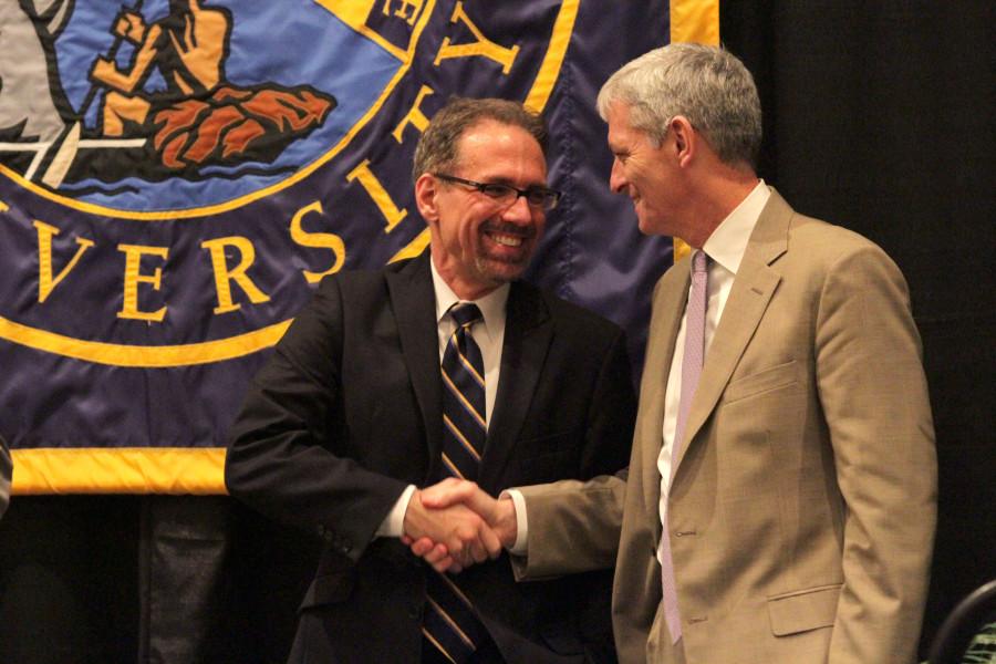 Provost Daniel Myers (left) and University President Michael Lovell (right) shake hands. Photo by Vale Cardenas.