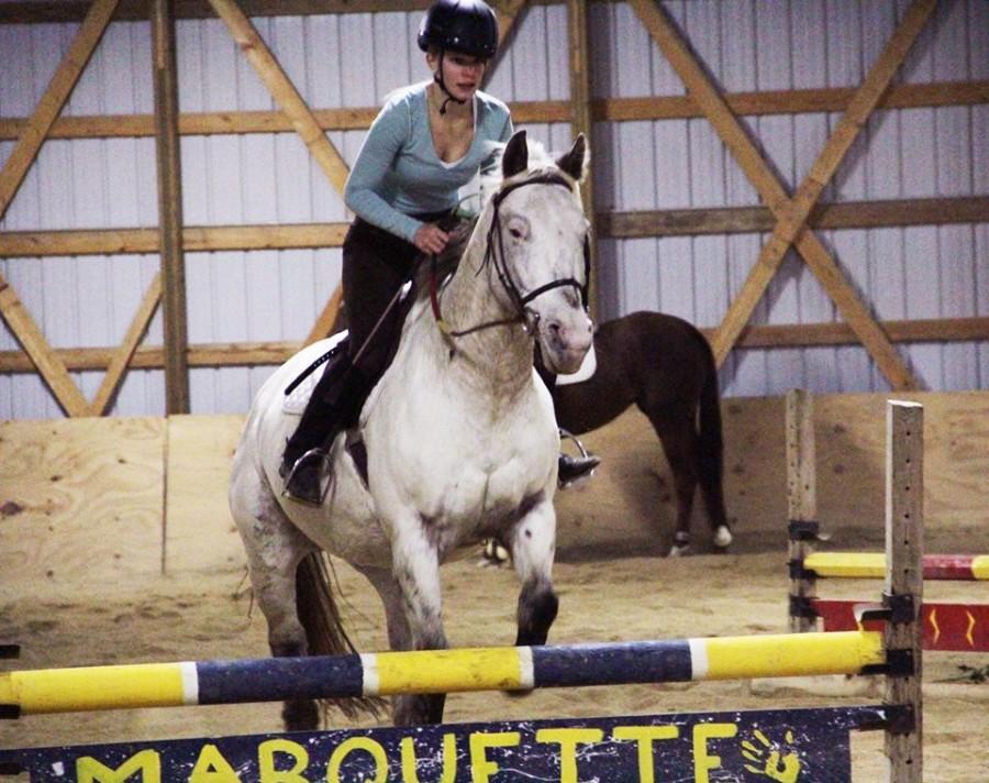 Junior Natalie Ullrich rides over a hurdle. Photo by Lily Stanicek/lily.stanicek@mu.edu