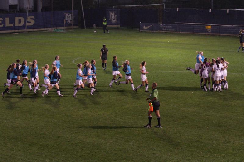 Womens soccer celebrates after Cali Pyzdrowskis golden goal in the 92nd minute. Photo by Doug Peters/douglas.peters@marquette.edu