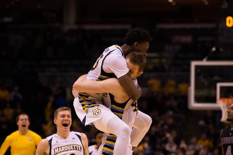 Luke Fischer and Jajuan Johnson celebrate following the final buzzer (Photo by Meredith Gillespie)