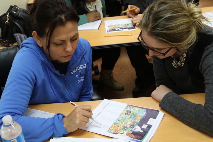 Michelle Frederick helps Ana Garcia with english. 