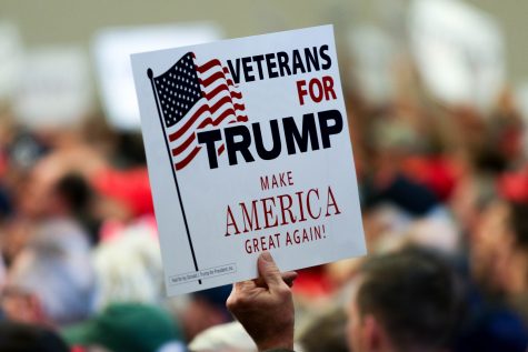 Trump supporters hold many signs to support the presidential candidate.