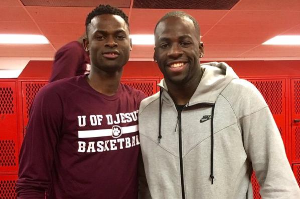 Ike Eke (left), stands with Warriors forward Draymond Green (right).