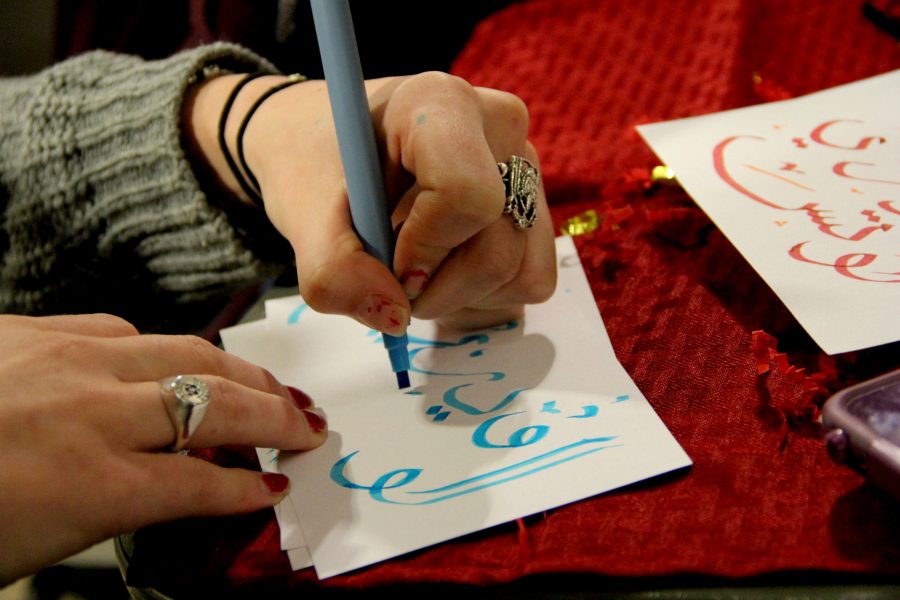 Arabic Language and Culture Club member Audrey Lodes practices Arabic calligraphy. Wire Stock Photo