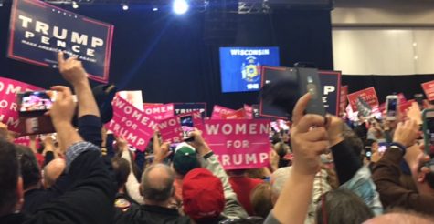 Audience members wave their signs in anticipation for President-Elect Donald Trump to take the stage. 
