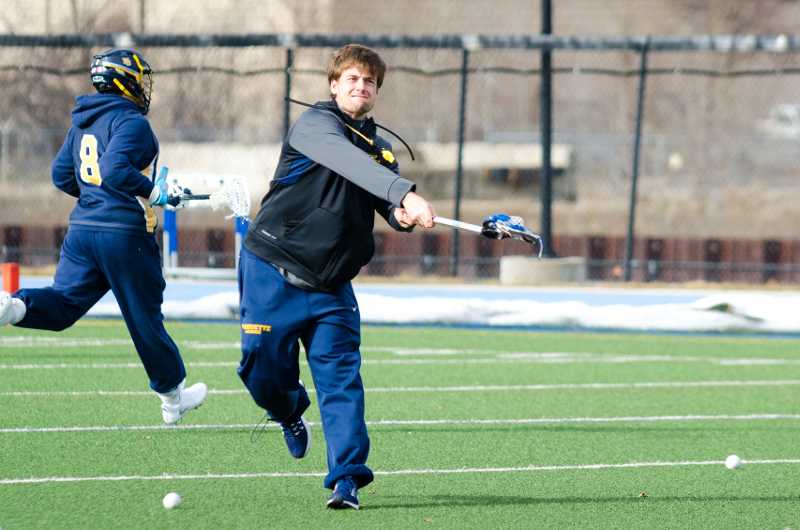 Ryan Brown warms up goalie Cole Blazer during a practice in January.