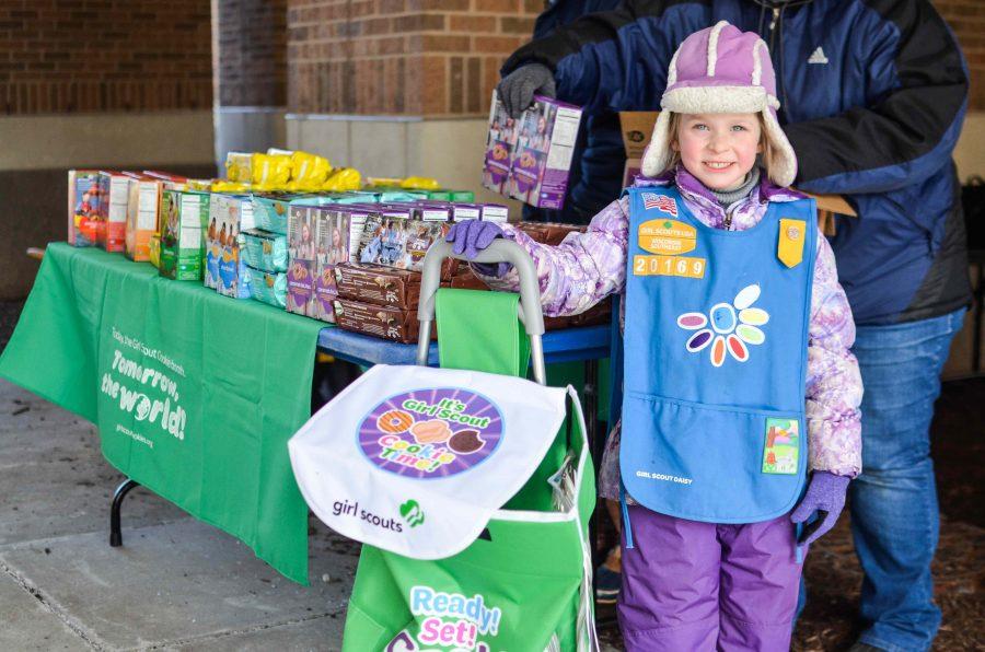 Julianna Tarpinian-Kitelinger, a Daisy Girl Scout, shows off her delivery cart. She sells door-to-door and also at booths.