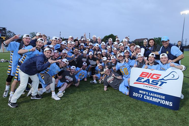 The mens lacrosse roster celebrates after winning the BIG EAST championship.