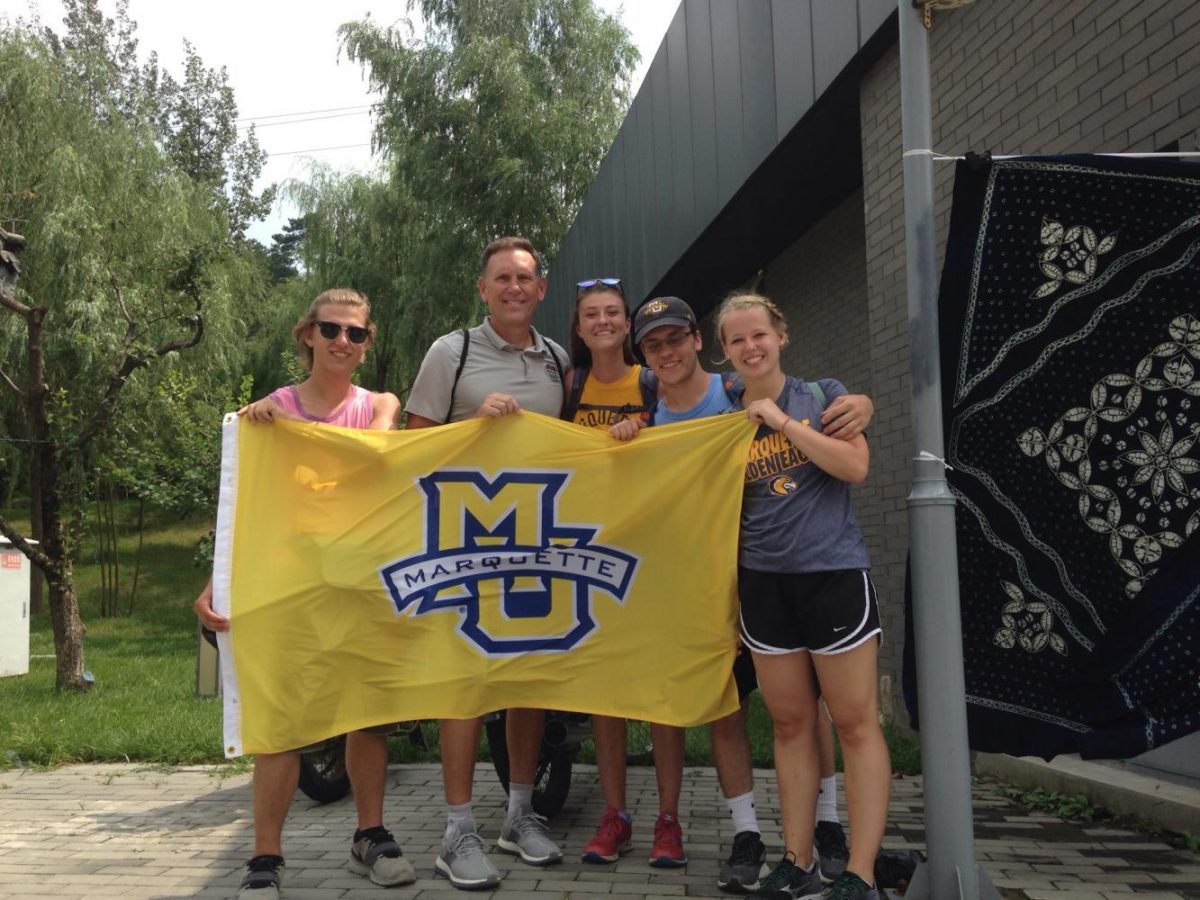 Mens basketballs new special assistant to the head coach Rob Judson (second from left) poses with Marquette study abroad students in China. (Photo courtesy of Rob Judson.)