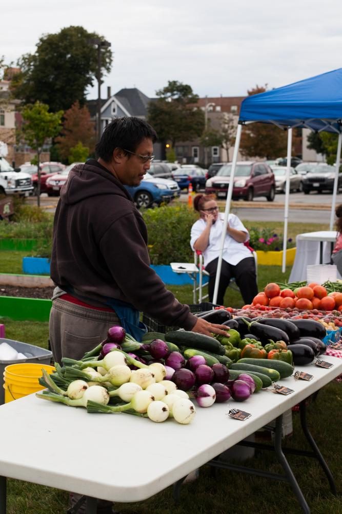A customer looking at fresh produce at the Near West Side farmers market.