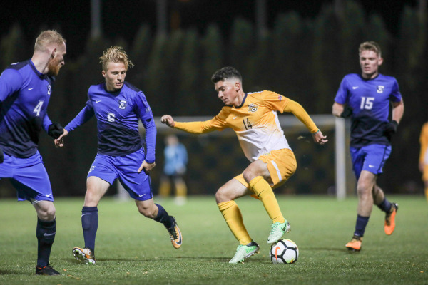 Luka Prpa attempts to dribble around three Creighton defenders in Marquettes 4-3 thriller Wednesday night. Prpa tied a program record with four assists.