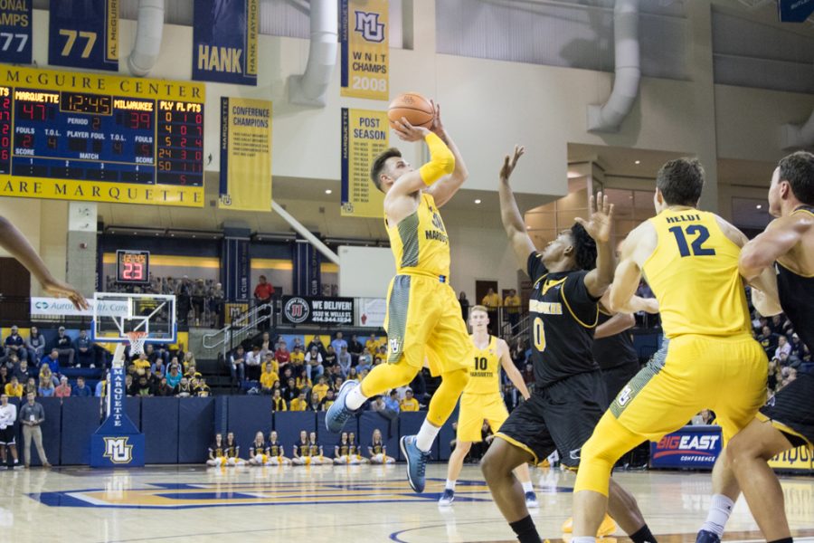 Senior Andrew Rowsey elevates for a three-pointer in the preseason scrimmage against UW-Milwaukee.