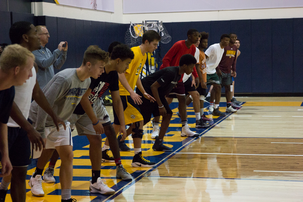 All the tryout participants line up on the baseline in preparation for wind sprints.