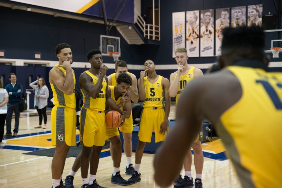 Freshmen Theo John (left) and Greg Elliott (second from right) pose for a picture with teammates while fellow freshman Ike Eke takes their picture.