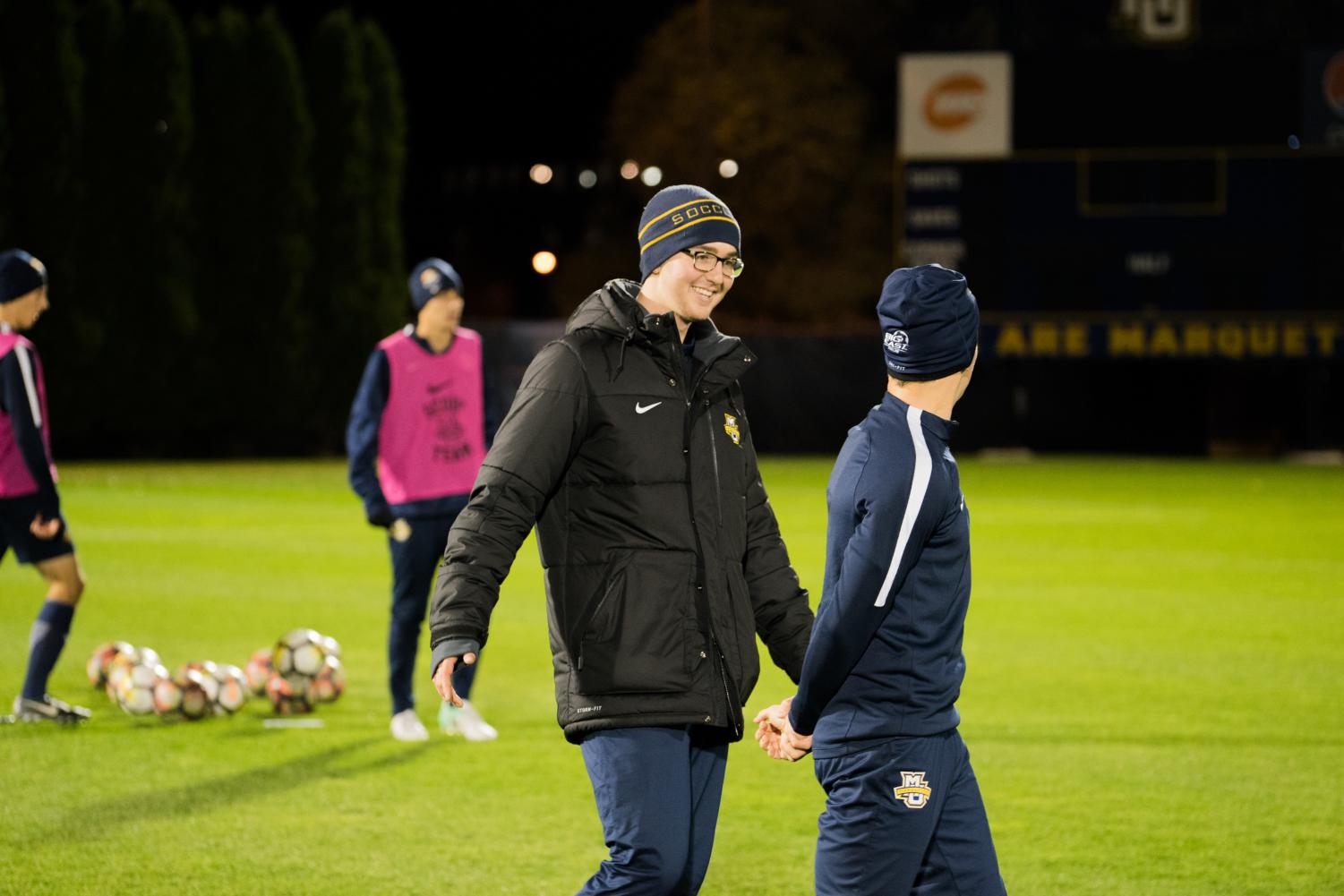 Danny Jarosz (center) talks to student manager Michael Gallo during an evening practice. Jarosz is in charge of filming every match and submitting it to InStat for a film breakdown.