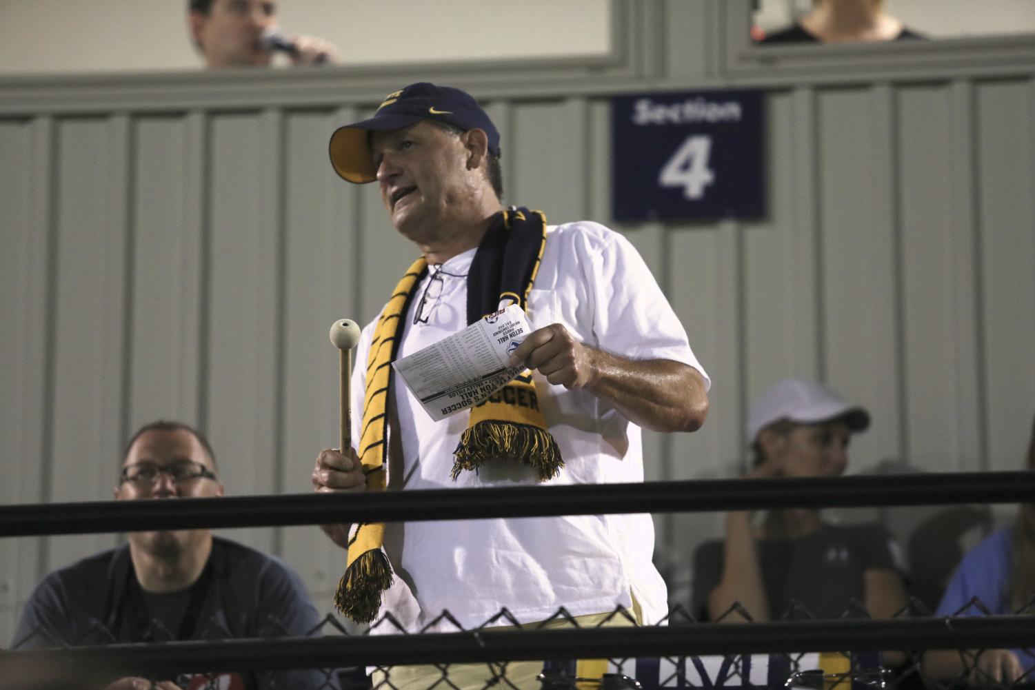 David Heim, also known as Drum Guy, yells encouragement to the men's soccer team.