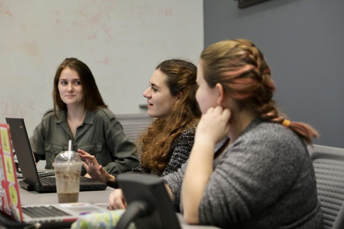 From left to right: Paula Van Camp, Colleen Pawlicki and Kathleen Baert participate in discussion in a Girls Who Code meeting.