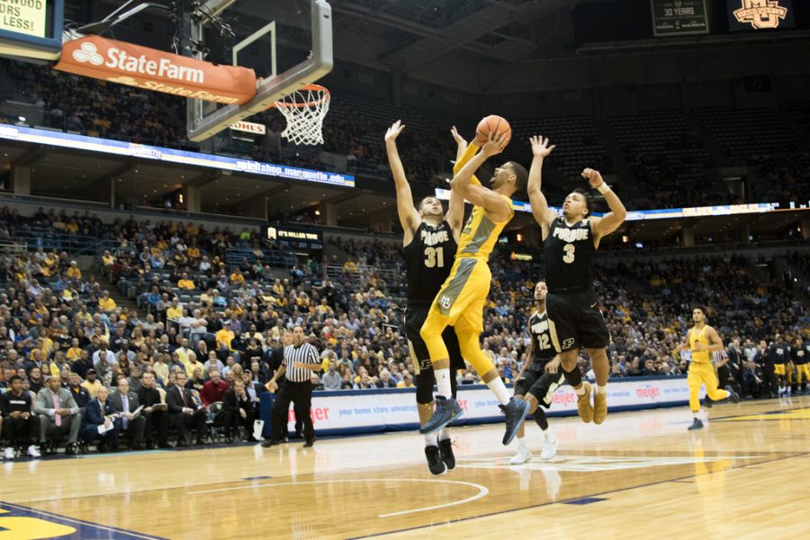 Haanif Cheatham fights off a Purdue double-team. He will leave Marquette effective immediately.