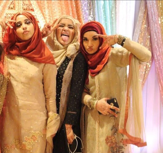 Aminah and her mother (right) pose for a picture at a family members wedding.