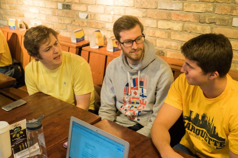 From left to right, engineering students TImothy Fair, Sam Goulet and Shaun Plunkett discuss their senior design project. 