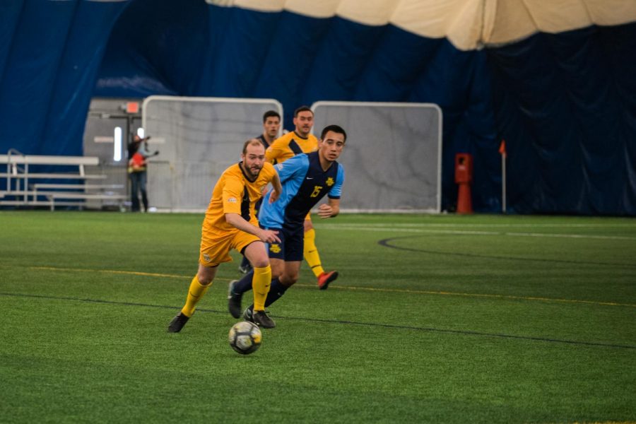 Nathan Sabich (left) goes for the ball in the mens soccer alumni game. Sabich played at Marquette from 2003 to 2006.