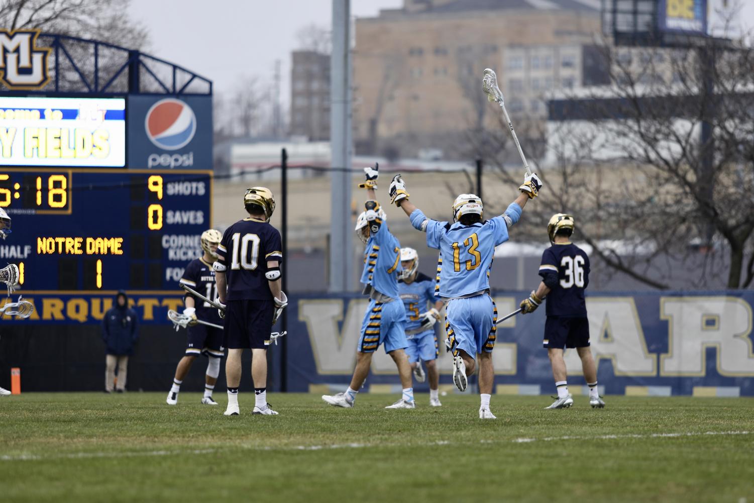 Connor McClelland celebrates with teammate John Wagner after a goal in the first half against Notre Dame. Marquette plays Providence Saturday afternoon.