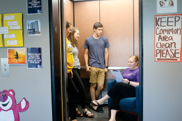 Students participate in elevator Cash Cab, where they are asked riddles. 