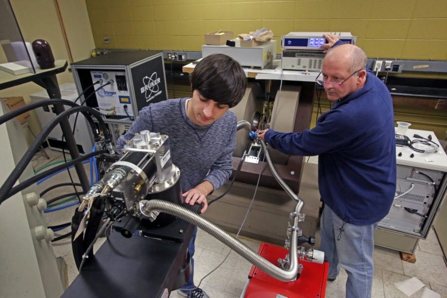 Former undergraduate student, Anthony Franciso and Dr. Brian Bennett use EPR machine. 