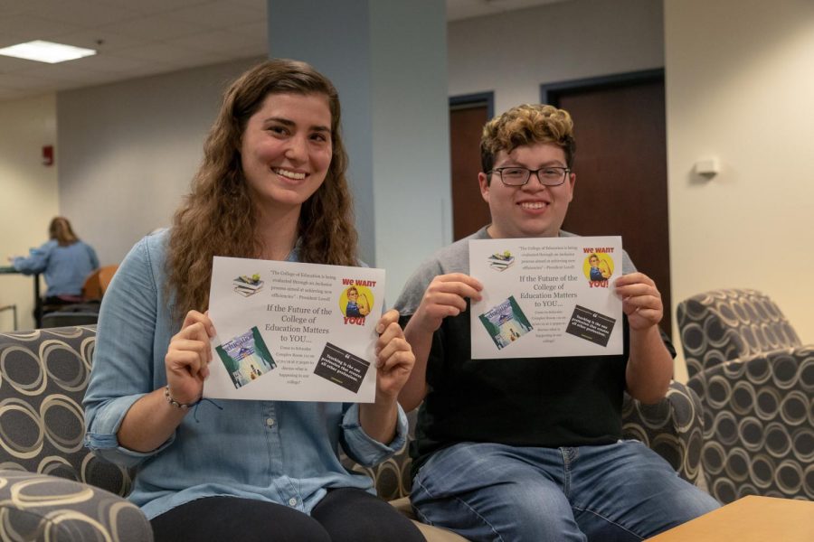 Brooke McArdle and Jonathon Jimenez hold fliers they created for an event this Friday to talk about the future of the College of Education. 