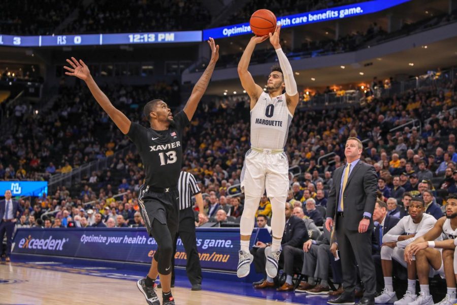 Markus Howard (0) shoots a shot in front of Marquettes bench in the Golden Eagles 70-52 win over Xavier at Fiserv Forum last season. Howard scored a 26 points. (Photo courtesy of Marquette Athletics.)