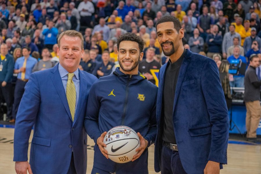 Markus Howard poses with head coach Steve Wojciechowski (left) and Lawrence Moten (right) after receiving the game ball from Moten.