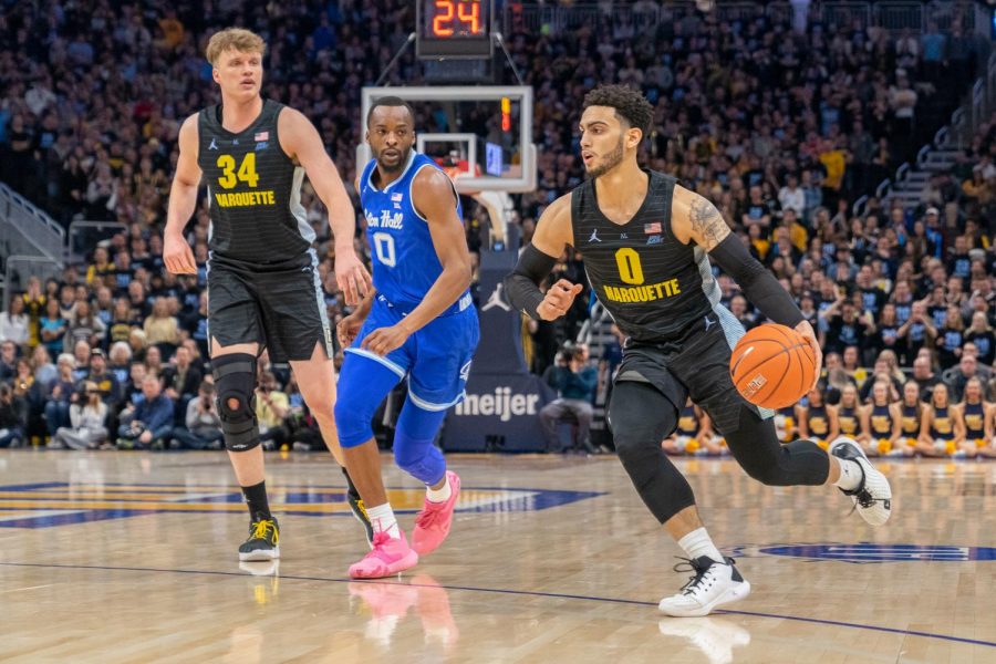Markus Howard (0) dribbles the ball past a Seton Hall defender in Marquette's 88-79 loss against the Pirates.