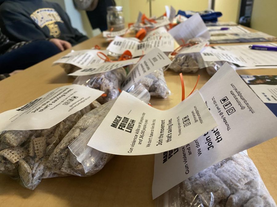 Puppy Chow sold at the March for Our Lives bake sale with statistics on gun violence and an orange ribbon, representing gun violence awareness.