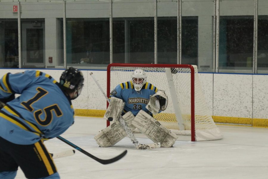 Jimmy Bertane (33) attempts to block a shot in Marquette club hockeys win over Bradley Friday night. 