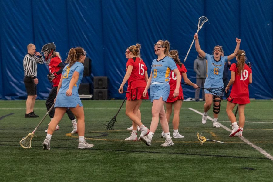 Megan Menzuber (9) celebrates after scoring a goal in Marquettes 17-6 win over Cincinnati. She led the team with six goals, tying a program high for most goals in a game. 