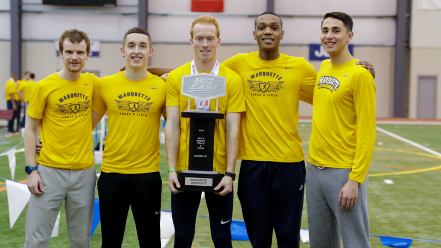 Members of the Marquette mens track and field team pose with the runner up trophy. (Photo courtesy of Marquette Athletics.)