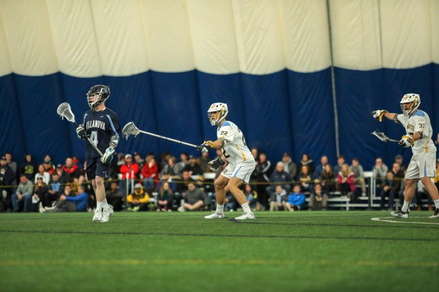 Cole Froemming (22) defends against Villanova in 2018. (Photo courtesy of Marquette Athletics.)