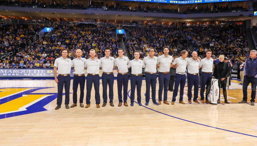 Matt Bachmann (second from left) and the golf team is recognized at the Feb. 26 mens basketball game. (Photo courtesy of Marquette Athletics.)