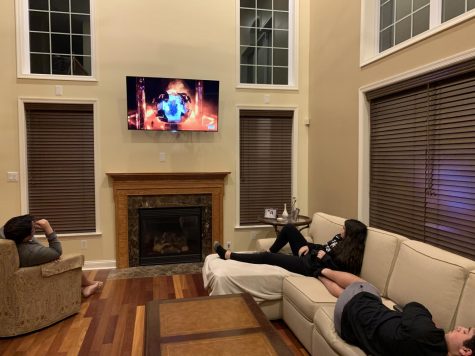 John Leuzzi (left) watches TV with siblings Victoria (top right) and Nick (bottom right) April 29. Photo courtesy of John Leuzzi. 