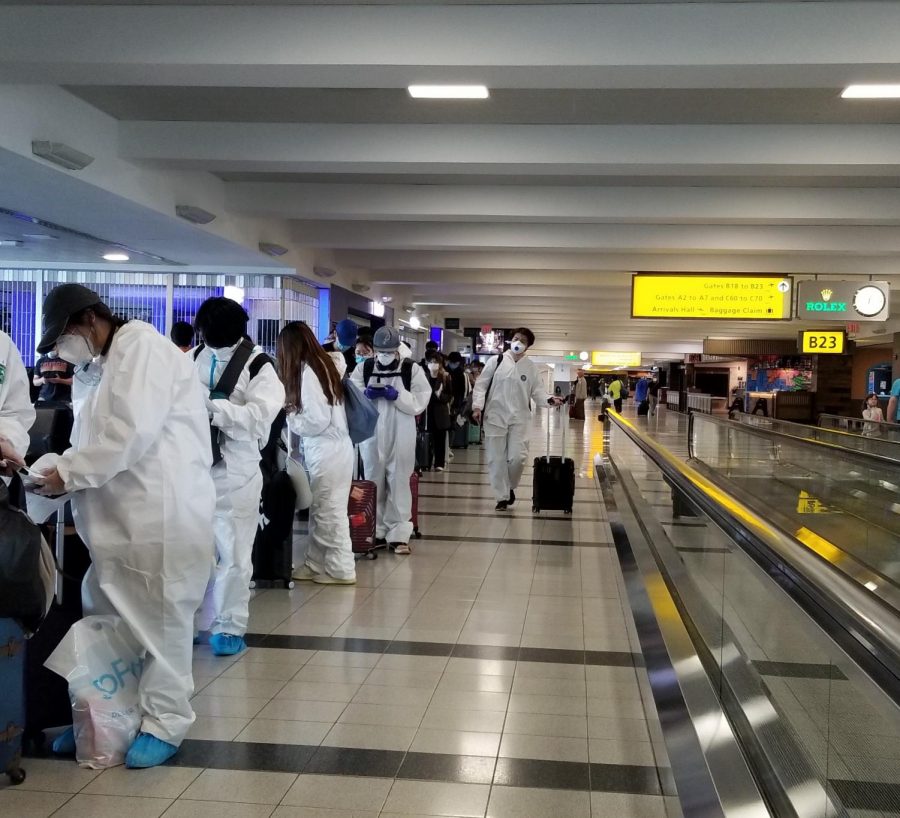 People in the airport wear protective equipment. 

Photo courtesy of Henry Yang