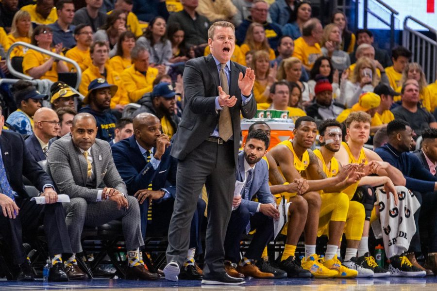 Head mens basketball coach Steve Wojciechowski coaches from the sidelines on National Marquette Day Feb. 9. 