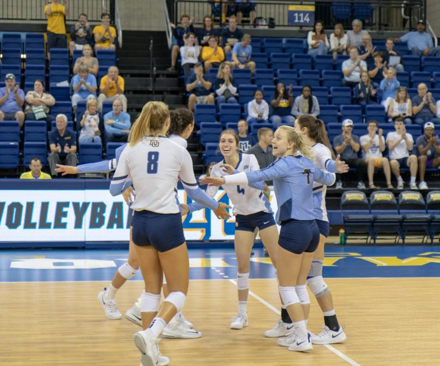 The+Marquette+womens+volleyball+team+celebrates+after+scoring+a+point+against+Syracuse+on+Sep.+7%2C+2019.+