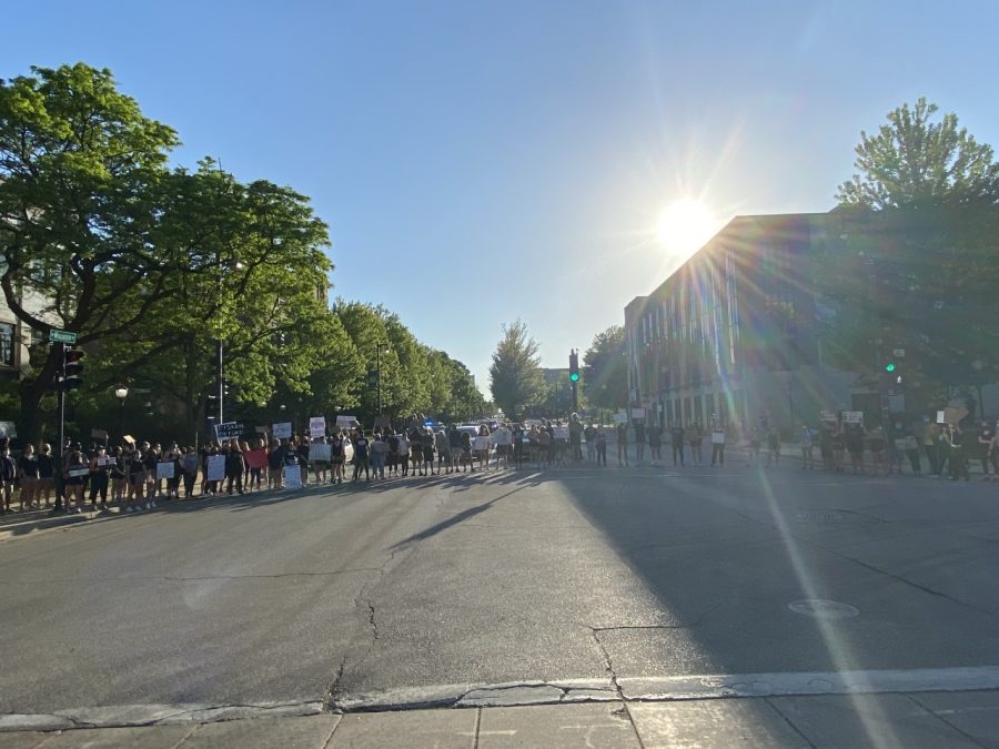 Protestors circle up at the intersection near Cudahy Hall and Varsity Theater. 